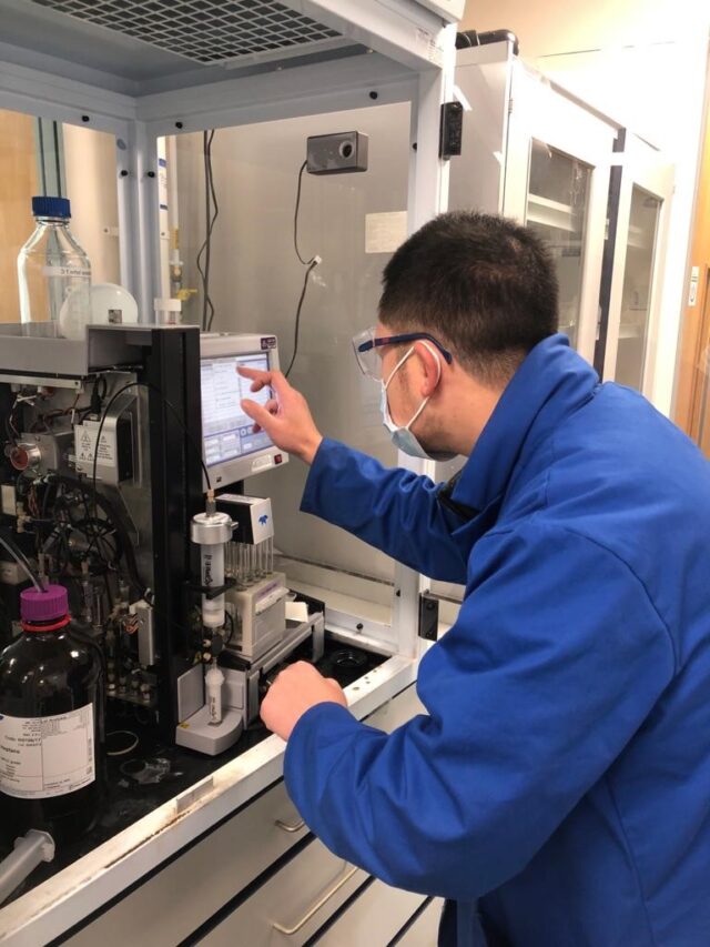 man fixing scientific equipment